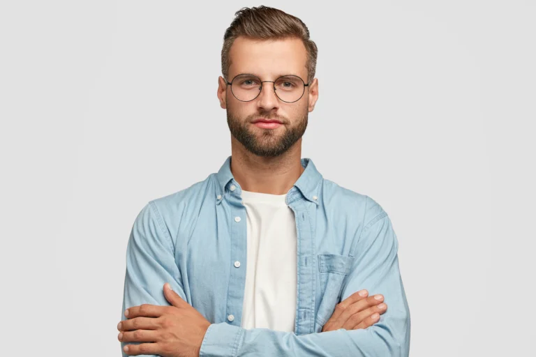 handsome-bearded-guy-posing-against-white-wall
